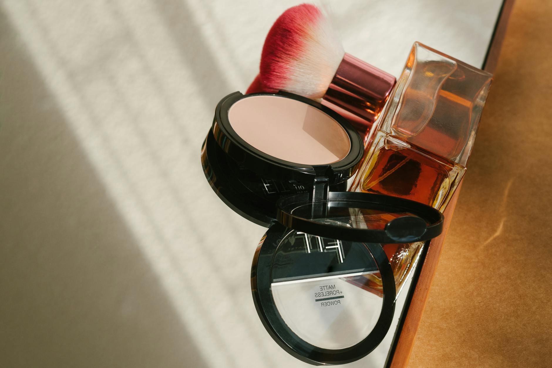 setting spray bottle on vanity with makeup brushes