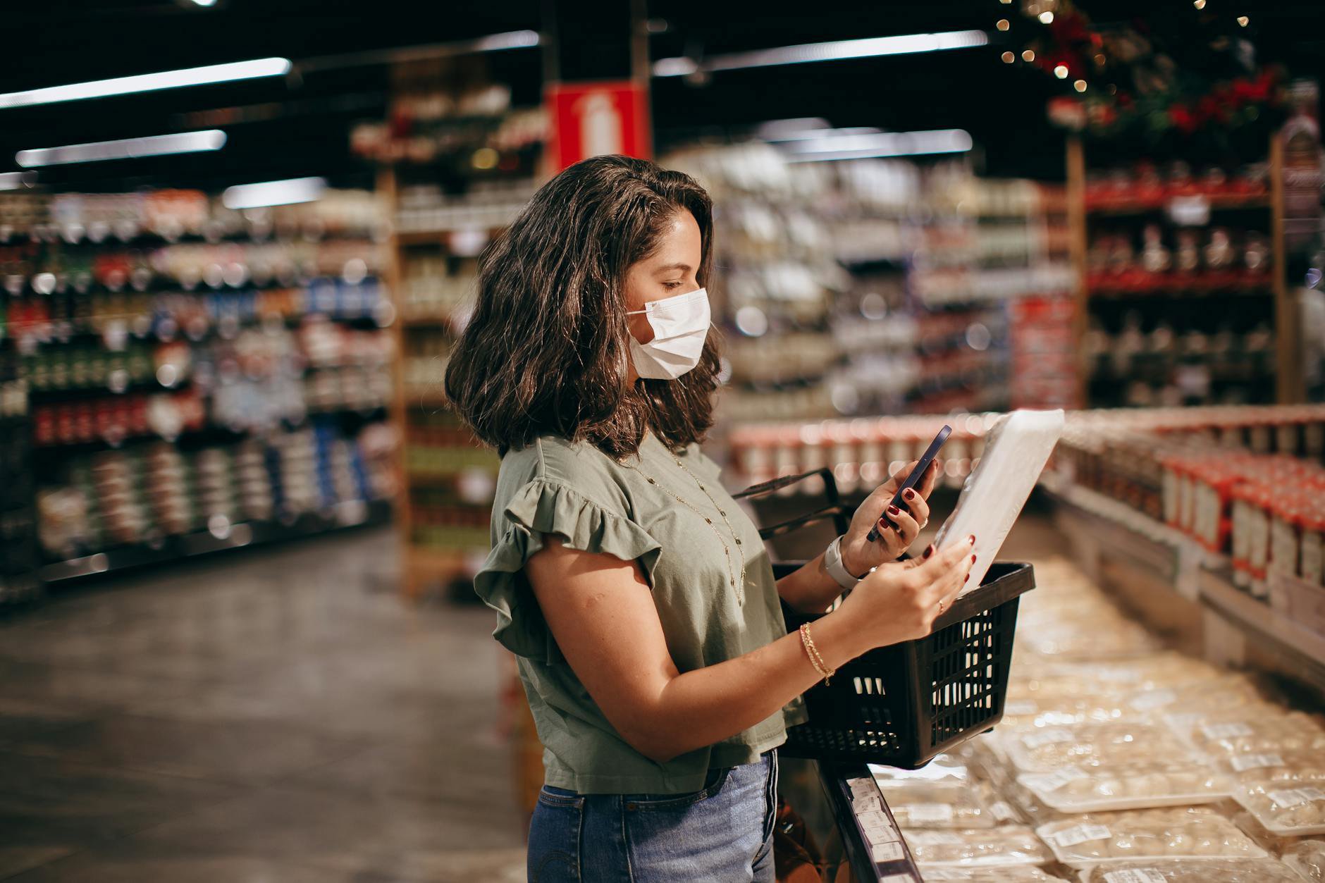 woman checking skincare products price tags Boots aisle