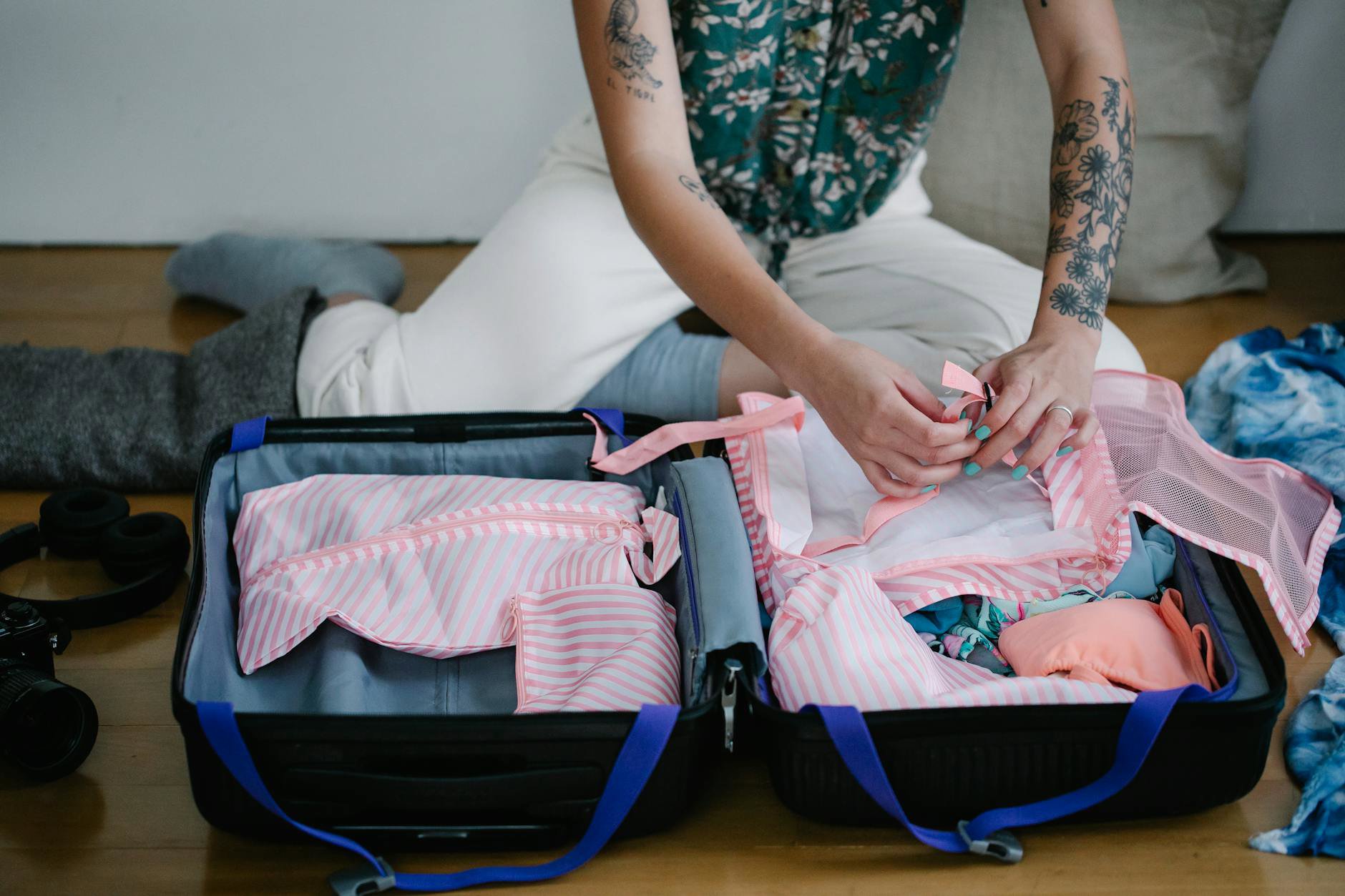 woman packing travel skincare toiletry bag