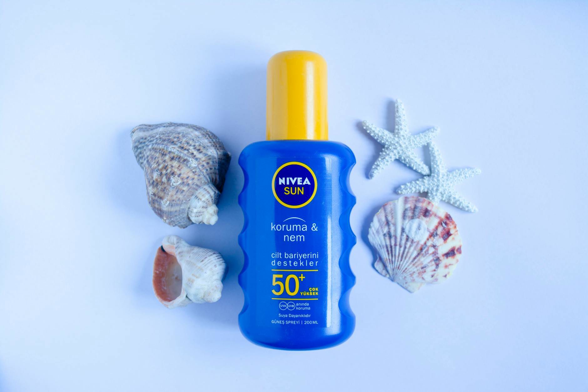 sunscreen bottles flatlay on white background