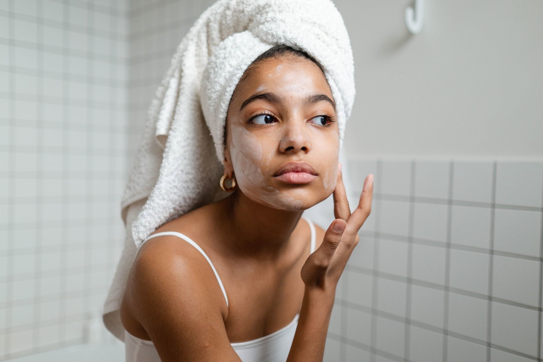 woman applying hair mask in shower