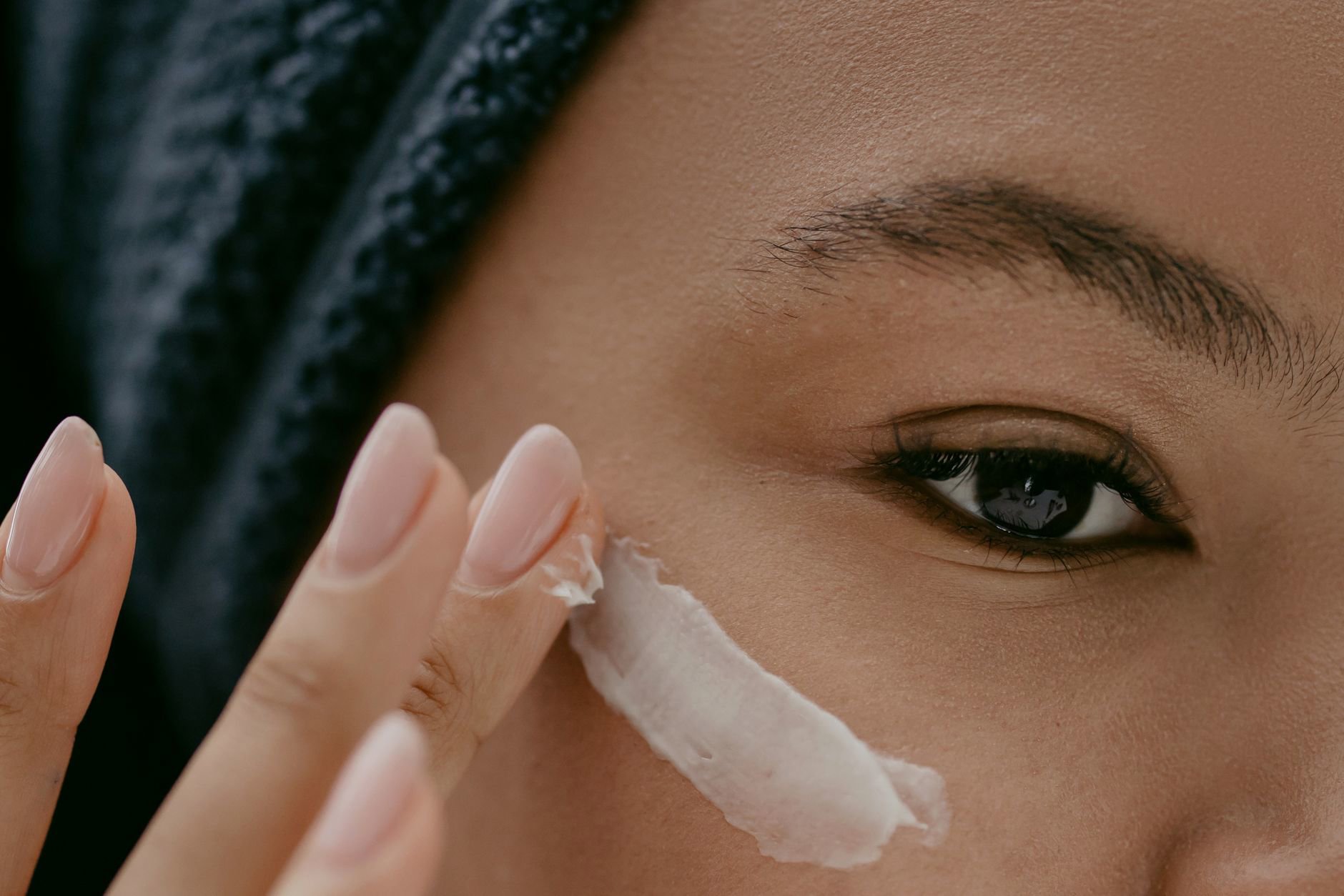 woman applying face cream winter dry skin