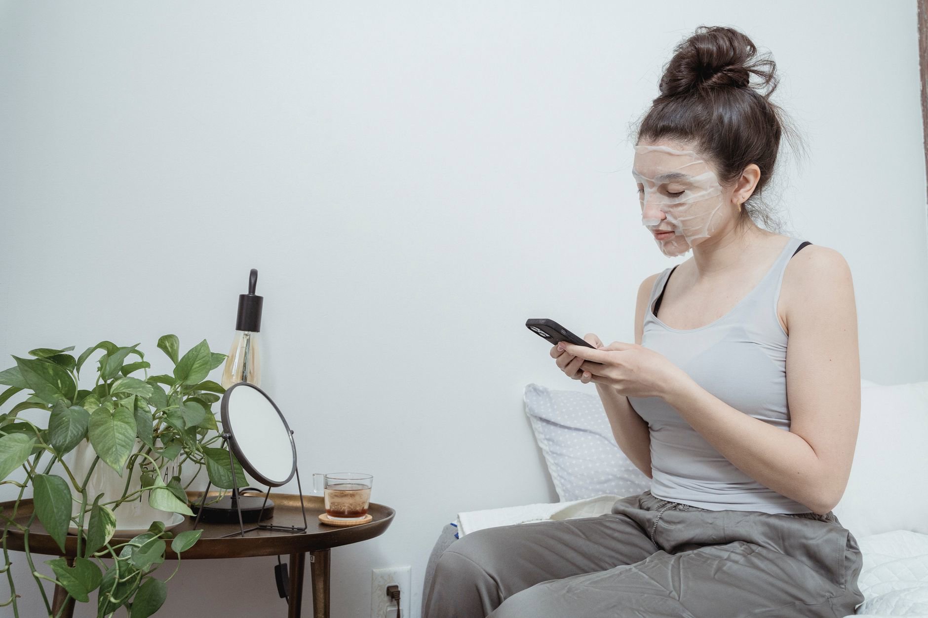 woman using LED mask at home night skincare